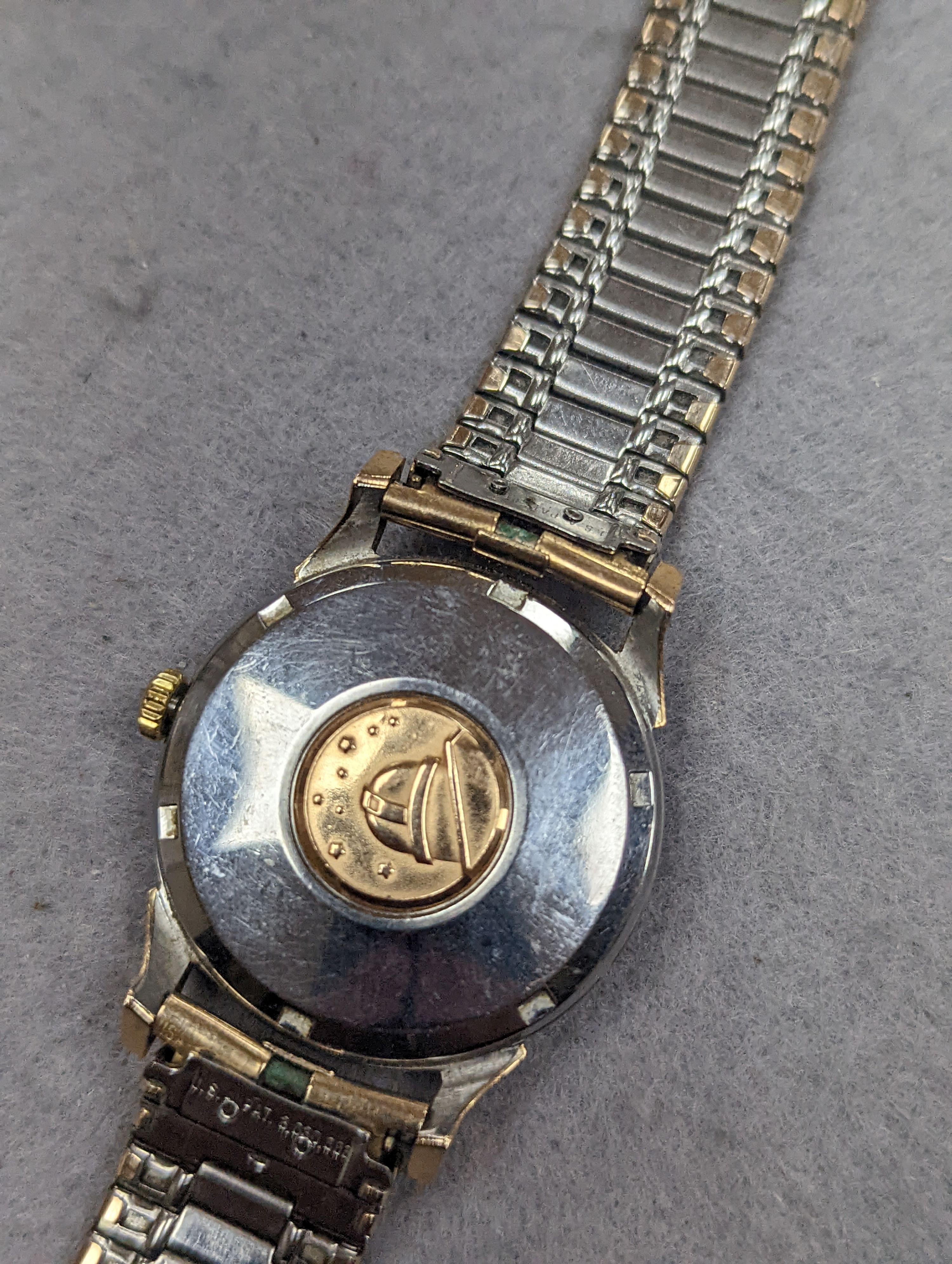 A gentleman's steel and gold plated Omega Automatic Constellation black dial wrist watch, on associated bracelet, case diameter 34mm (winding crown a.f.).